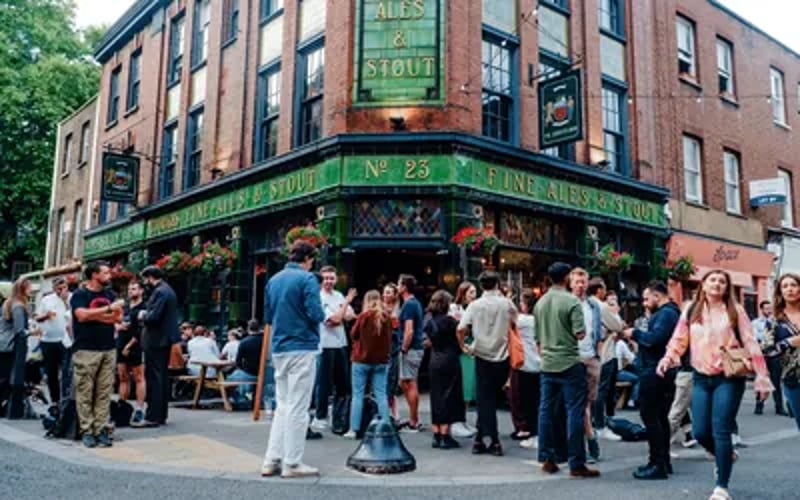 Victorian pub with a green-tiled facade, stained-glass windows and a large menu of bottled beers.