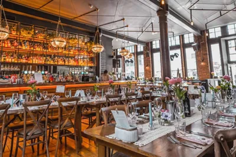 Situated on Farringdon Road in the heart of the city, this versatile wedding reception space in a Grade II listed, former printing press factory retains clues to its historic, industrial past with original exposed brickwork and industrial reliefs. The sizeable modern space boasts a stylish interior with a striking bar surrounded by large dining tables. Natural light fills the venue from large feature windows and skylights, with an outside patio area available. 