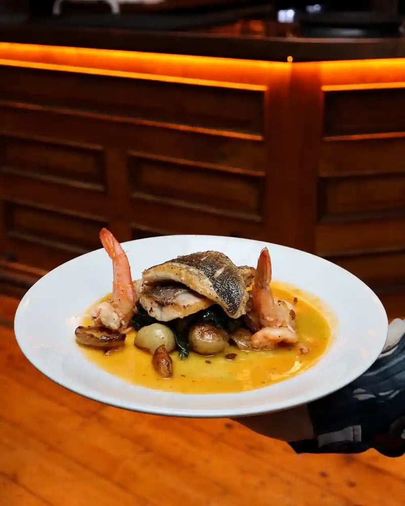 A plate full of comfort 🍽️ Cooked to perfection, our Pan-fried Sea Bass is not to be missed. Paired with tiger prawns, new potatoes, spinach, and lobster bisque. 🐟 

Save this for your next food craving 😋
